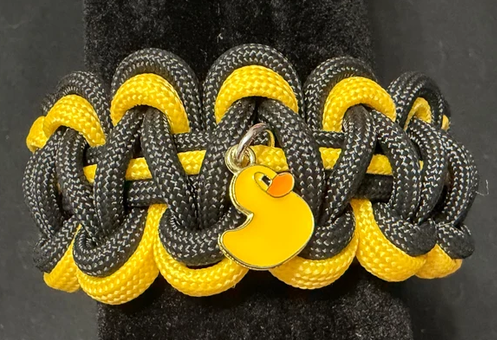 Handcrafted from durable yellow and black paracord, this bold bracelet celebrates the fun, friendship, and sense of community behind Jeep ducking.